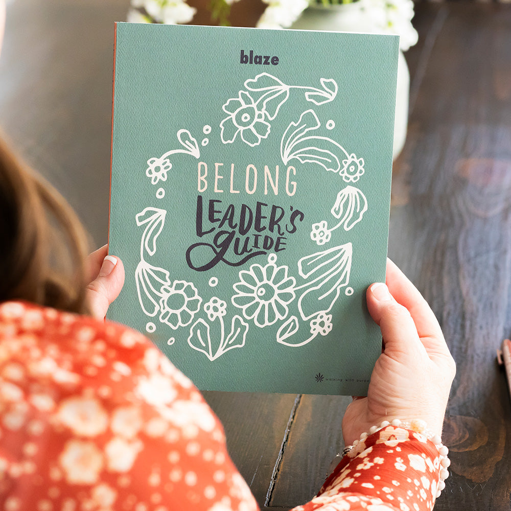 woman holding BLAZE Belong leader's guide