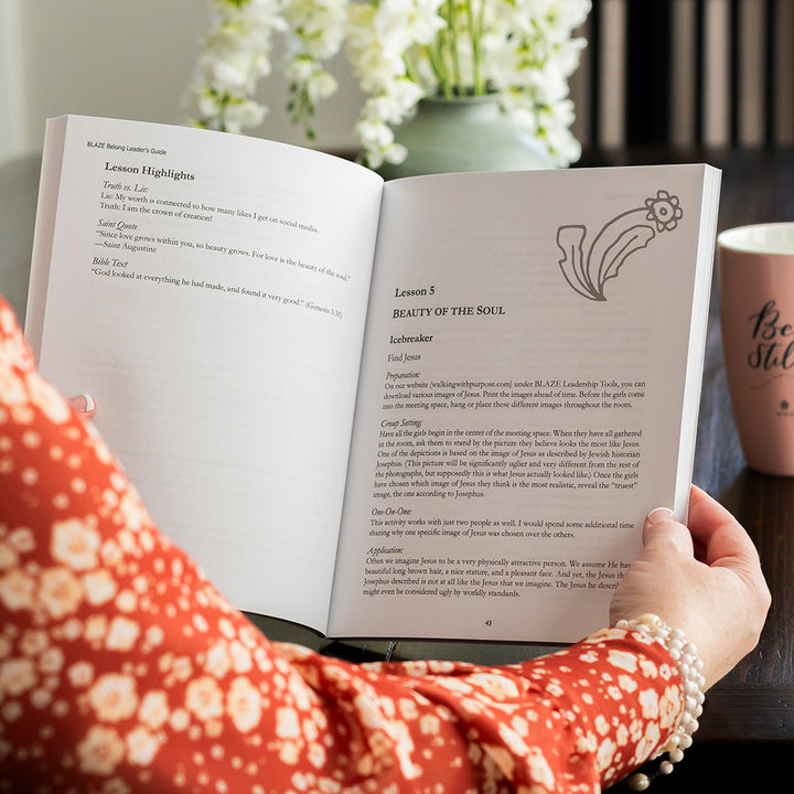 woman holding open BLAZE Belong leader's guide