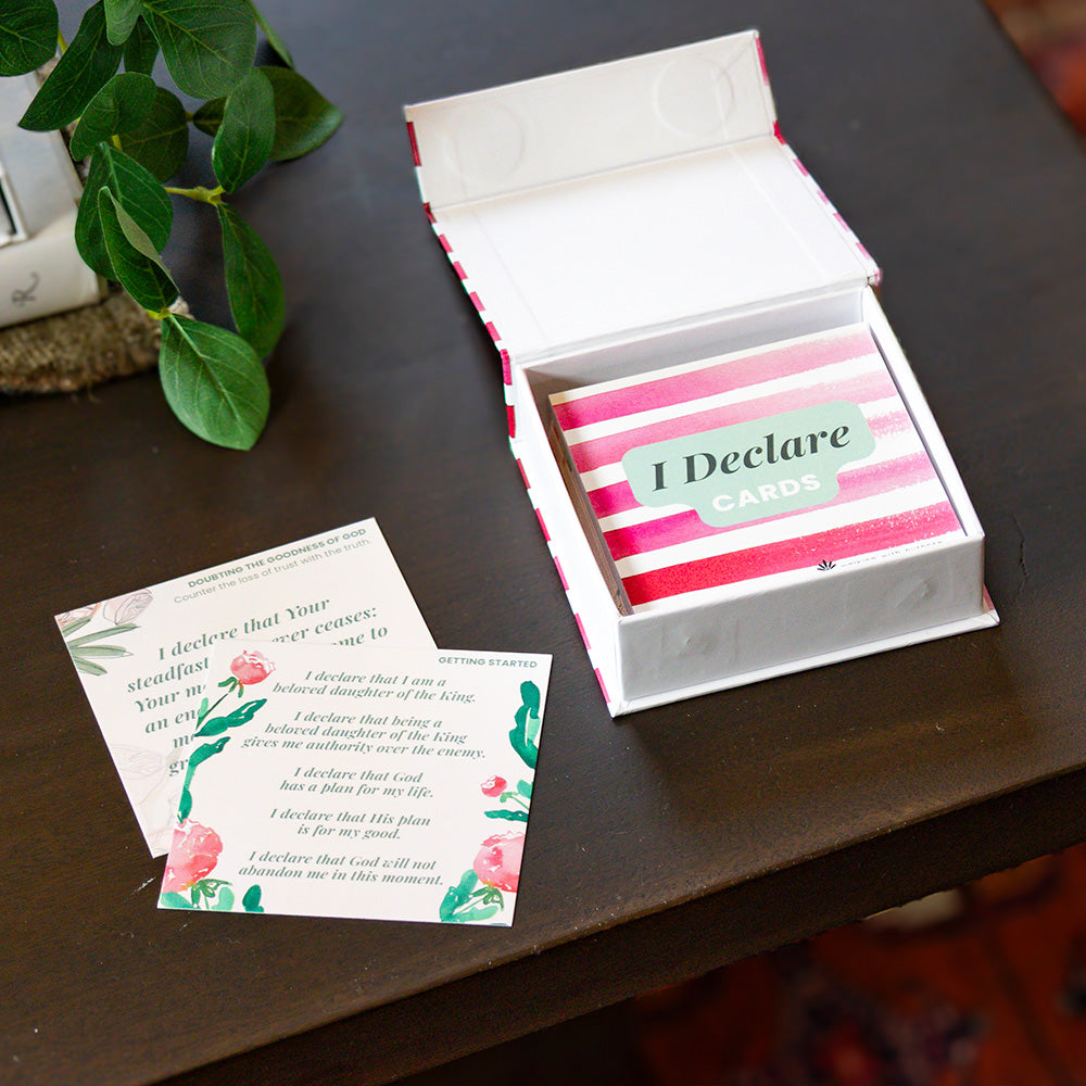 Box of 'I Declare' Scripture cards with a few cards on a wooden surface
