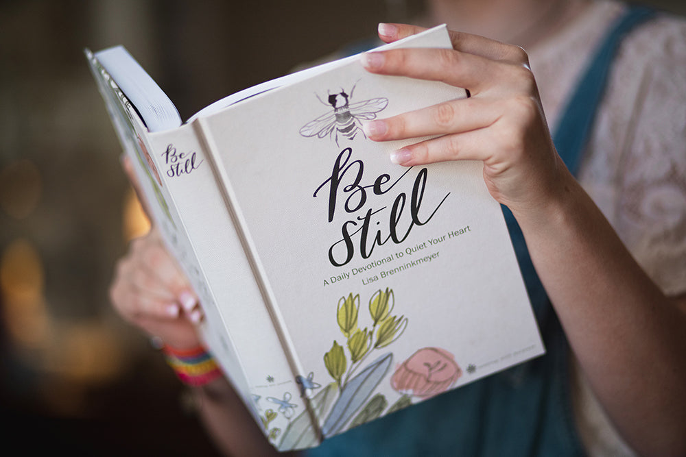 woman holding Be Still