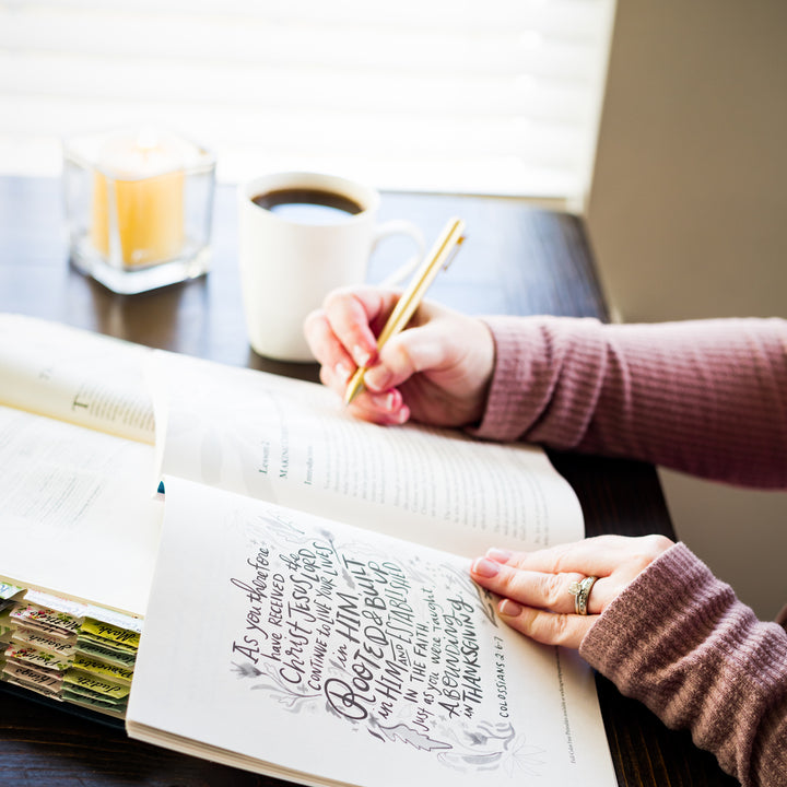 woman with Rooted and Radiant study guide with Bible open