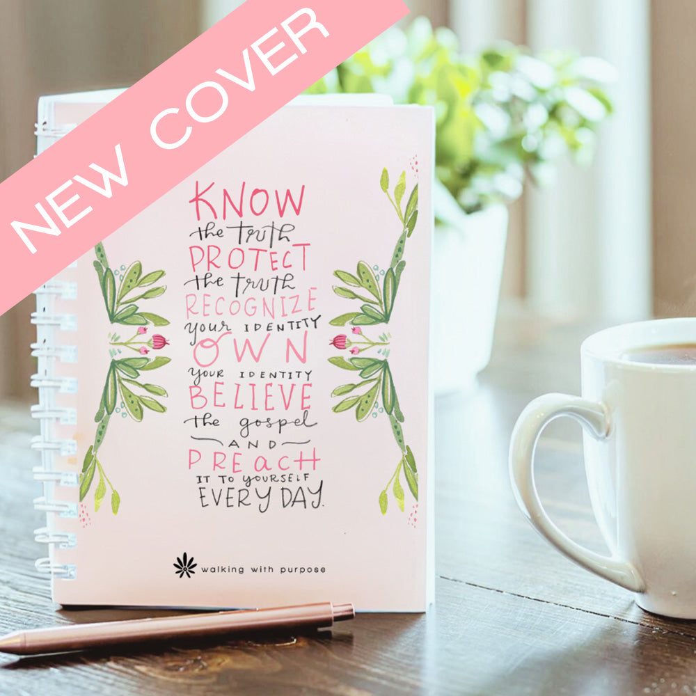 Notebook with Fearless and Free quote on a table with a mug and pen, labeled 'New Cover'.