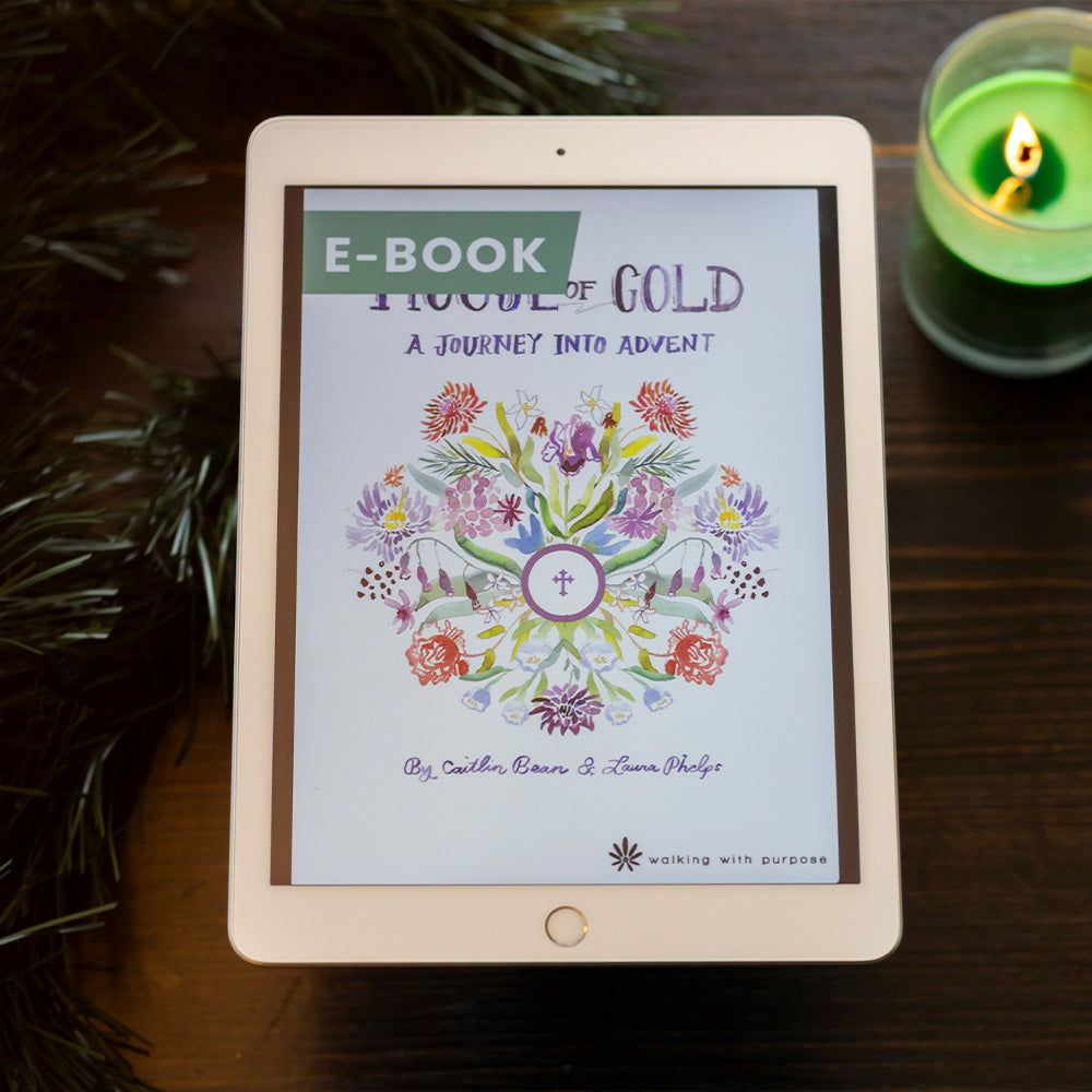 E-book titled 'House of Gold: A Journey into Advent'  displayed on a tablet with a candle and branches in the background