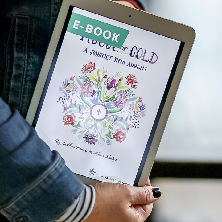 Woman holding a tablet with an e-book titled 'House of Gold: A Journey into Advent'  displayed on the screen.