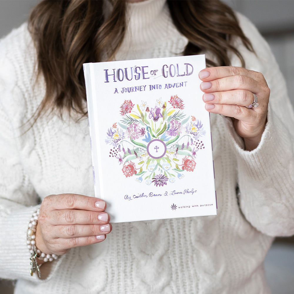 House of gold A Journey into Advent book cover with flowers and Eucharist host in center. held by a woman
