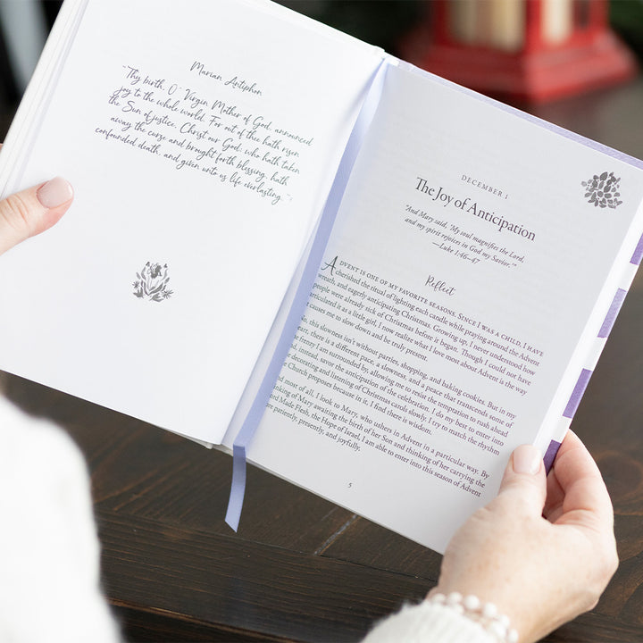 House of gold A Journey into Advent book open to a chapter titled "The Joy of Anticipation" held by a woman