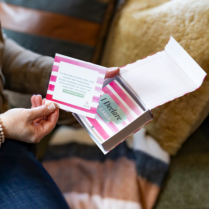 Woman holding box of 'I Declare' Scripture cards with one card out 