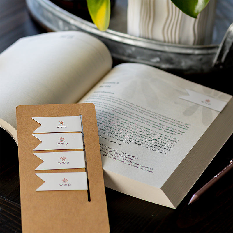 Walking with Purpose Magnetic Bookmarks designed with the signature WWP flower logo. One bookmark is on Bible study page. Remaining four bookmarks in the background.