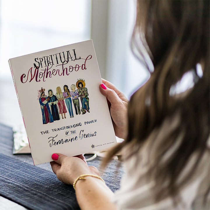 A woman holds a book titled &