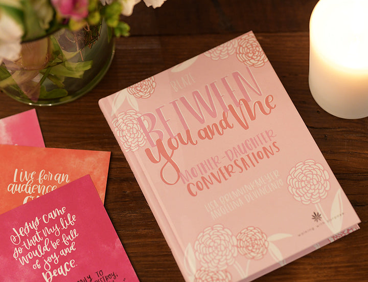 Between You and Me: Mother Daughter Journal and Devotional on a table
