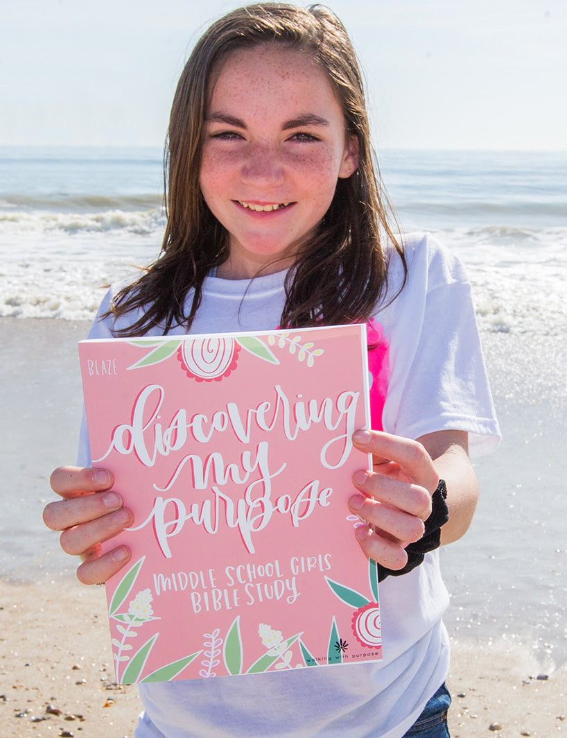 Girl at the beach holding Discovering My Purpose Bible Study
