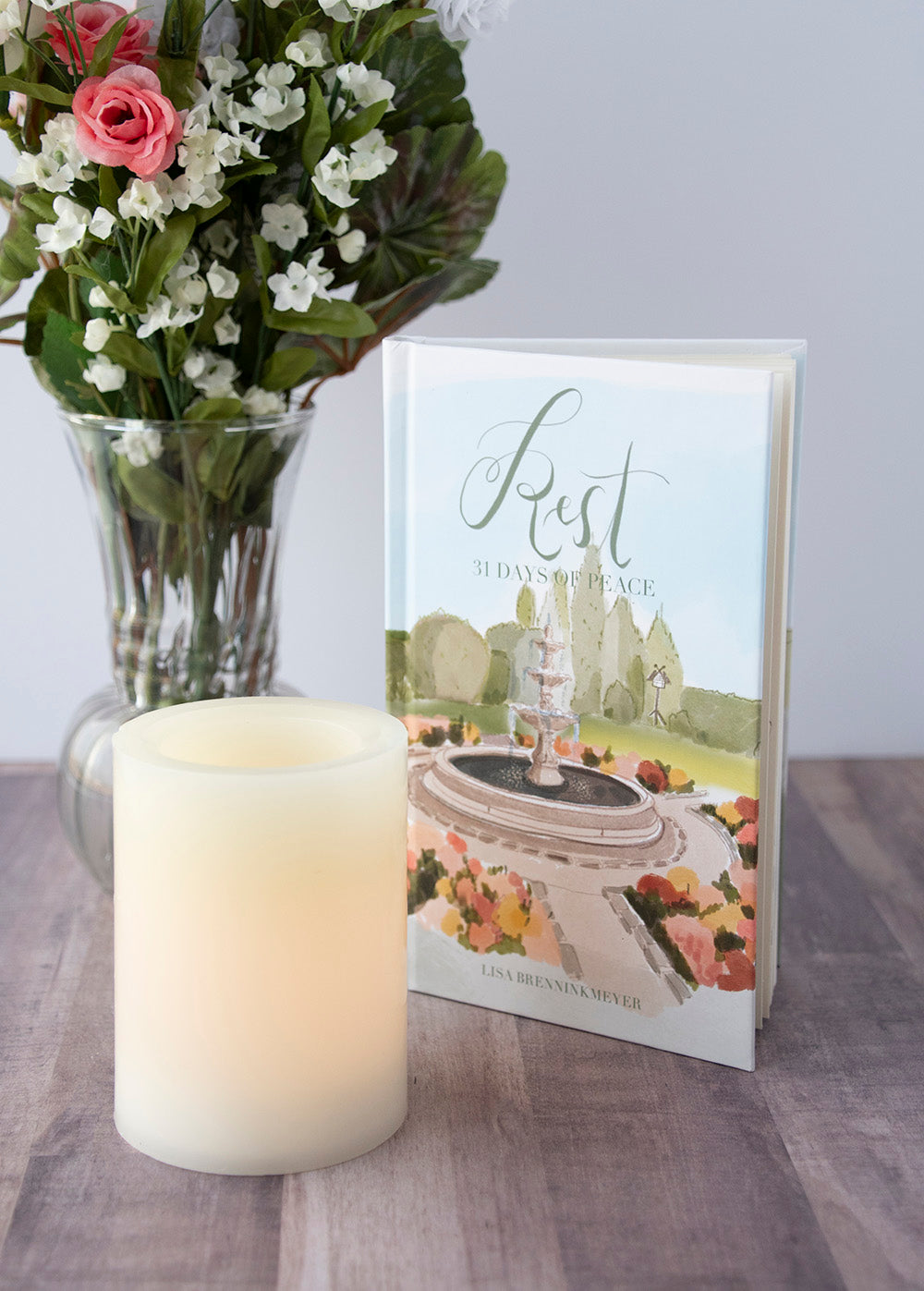 Rest: 31 Days of Peace Devotional with candle and flowers